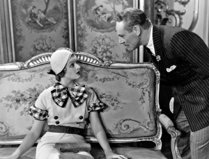 1932: Myrna Loy (1905 - 1993) looks up at Charles Ruggles (1886 - 1970), the American character comedian in a scene from 'Love Me Tonight', directed by Rouben Mamoulian for Paramount.